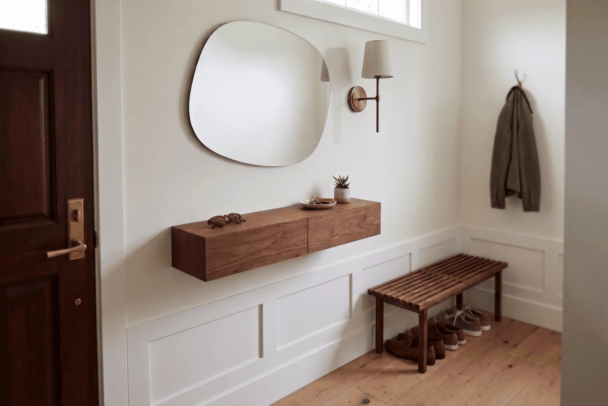 elegant entryway with walnut shelf