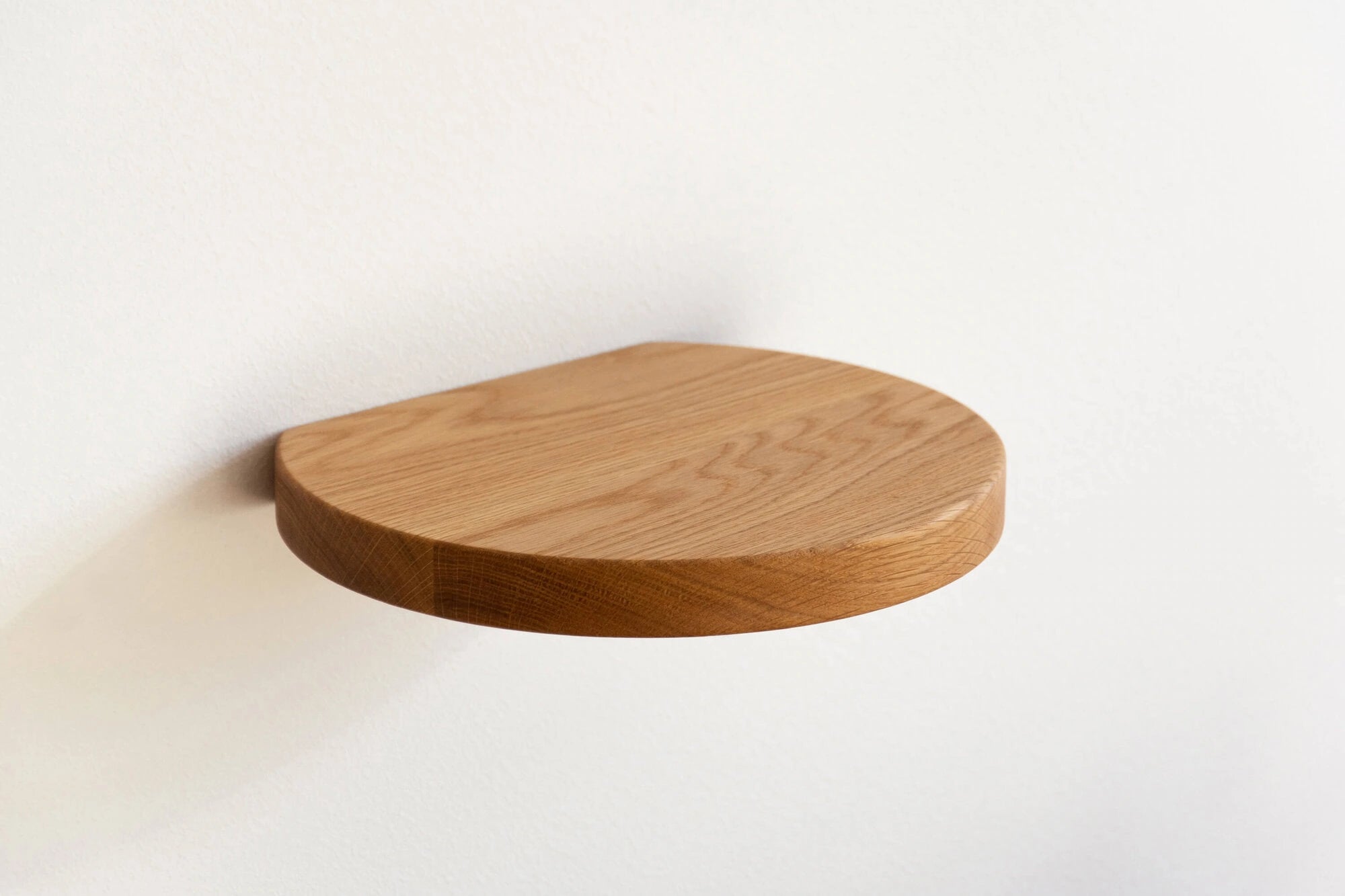 round floating shelf made of oak